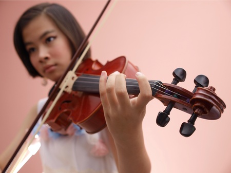 An Asian girl playing violinの写真素材