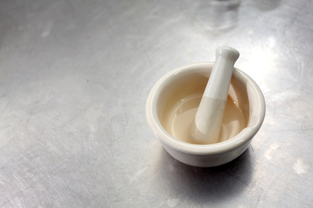 A white porcelain mortar on white backgroundの写真素材