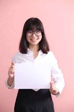 Asian girl holding blank sheetの写真素材