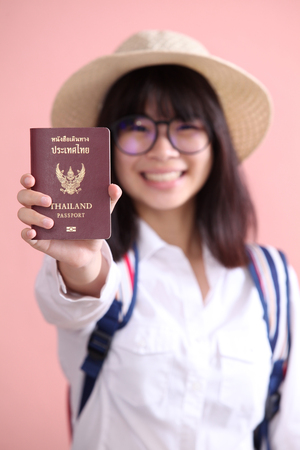 Asian girl holding passport to travelの写真素材