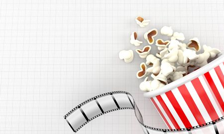 Popcorn with film strip on blank sheet of paperの写真素材