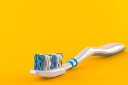 Tooth brush isolated on orange backgroundの写真素材