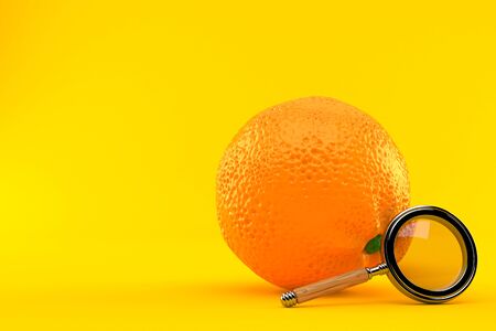Orange with magnifying glass isolated on orange backgroundの写真素材