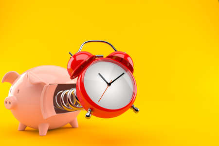 Piggy bank with alarm clock isolated on orange backgroundの写真素材
