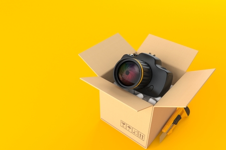 Camera inside cardboard box isolated on orange background. 3d illustrationの写真素材