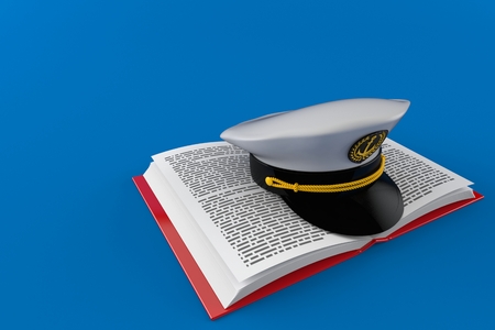 Captain's hat on open book isolated on blue background. 3d illustrationの写真素材