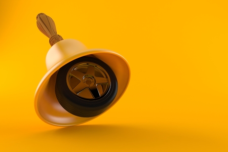 Handbell with car wheel isolated on orange background. 3d illustrationの写真素材