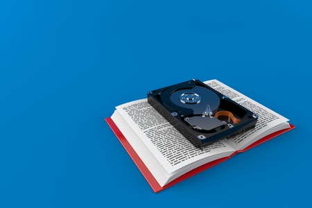 Hard drive on open book isolated on blue background. 3d illustrationの写真素材