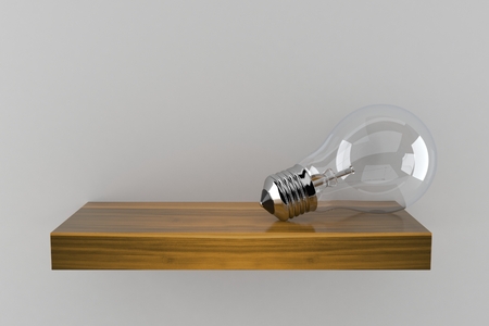 Light bulb on wooden shelf isolated on gray background. 3d illustrationの写真素材