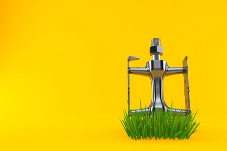 Bicycle pedal on grass isolated on orange background. 3d illustrationの写真素材