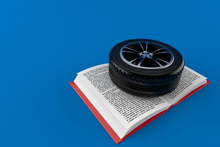 Car tire on open book isolated on blue background. 3d illustrationの写真素材