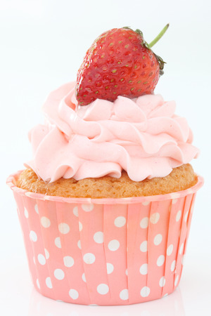 Delicious vanilla cupcake with strawberry frosting and fresh strawberryの写真素材