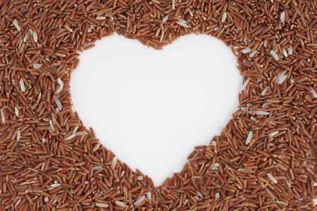Brown rice with heart shapeの写真素材