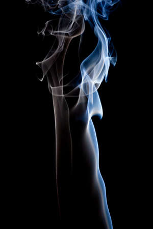 Colorful smoke abstract curly on black backgroundの写真素材