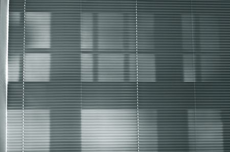 Light shining through bedroom blindの写真素材