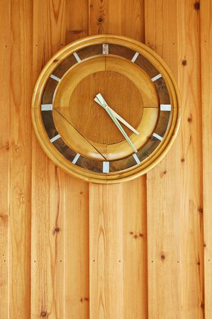 Finnish wooden clock on a wooden wall