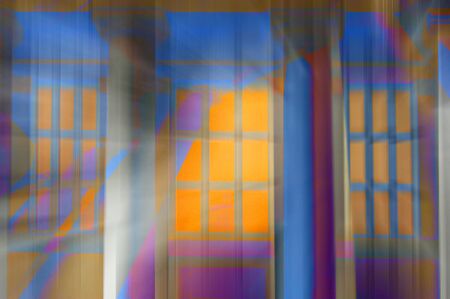Abstract design of light shining from a building's window