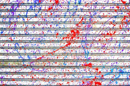 Paint randomly splattered onto a metal garage doorの写真素材