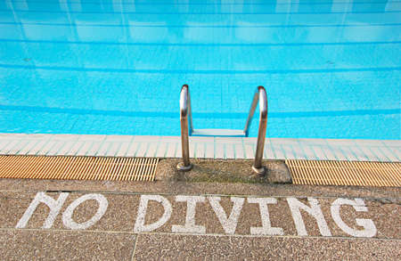 No diving sign at edge of swimming poolの写真素材