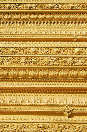 Decorative golden wall of a Thai templeの写真素材