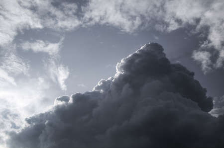 Cloudscape of a dark, pyramid shaped raincloudの写真素材