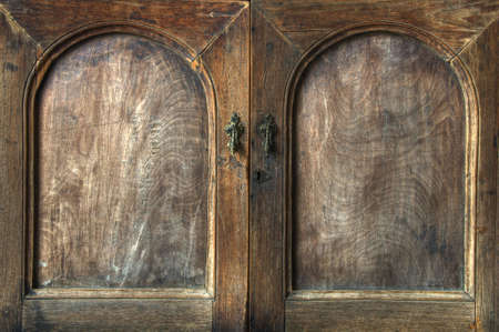 Doors on an old wooden cupboard with grain textureの写真素材