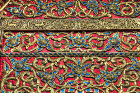 Ornate decoration of goldleaf and tiles from a Thai templeの写真素材