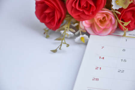 White desk calendar of February with rose flower, concept for valentines day on 14th February 2021.の写真素材