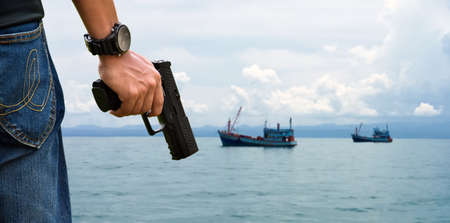 Automatic black 9mmx19 pistol holding in hands aiming to target shooting and ready to shoot, blurred...