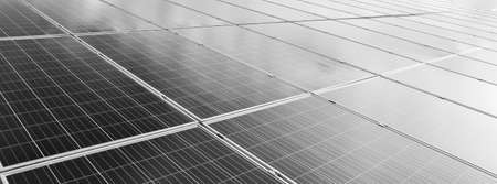 Photovoltaic panels installed on the toproof of the factory, sunlight cloudy and bluesky background. Sustainable energy concept.の写真素材