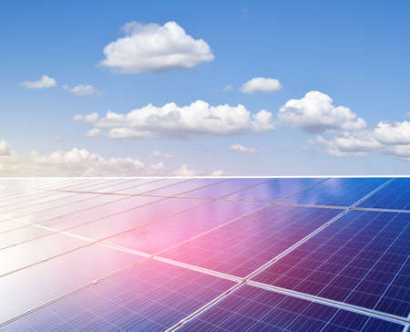 Solar rooftop of the building, cloudy and bluesky background. Soft and selective focus on solar panels.の写真素材