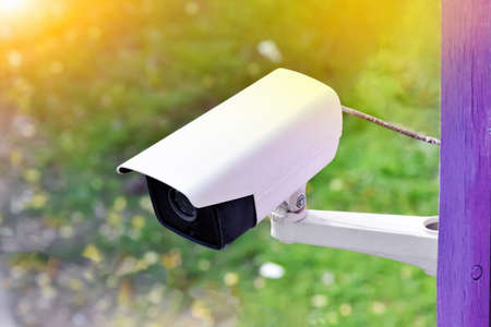 IP CCTV camera installed on the wall outside the house to do the security system by monitoring on mobile phone application when the owner wasn't at home. Soft and selective focus on cctv cemera.の写真素材
