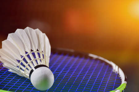 Closeup view of badminton racket and white badminton shuttlecock on badminton court. soft and selective focus on shuttlecock.の写真素材