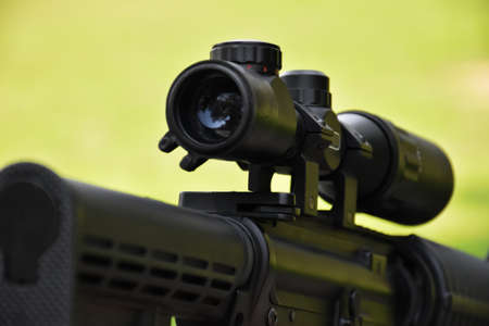 Binoculars of black automatic rifle Long-barreled at the training ground, also known as Air Soft or BB Gun. Use bullets made with spherical plastic beads. Soft and selective focus on binoculars.の写真素材