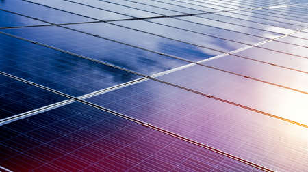 Photovoltaic panels with reflection of the Sunlight and clouds on the surface.の写真素材