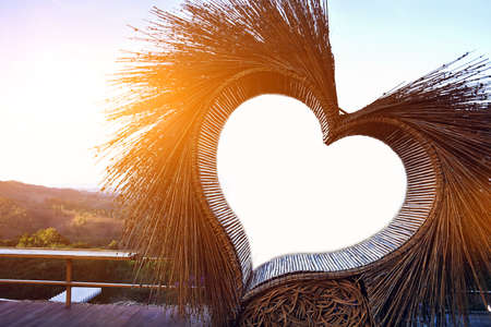 Chair in heart shaped nest which made from wood, twing or limp for sitting to relax, celebrate or take a photo, soft and selective focus, copy space.の写真素材