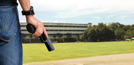 9mm automatic pistol holding in right hand of shooter, concept for security, robbery, gangster, bodyguard around the world. selective focus on pistol.の写真素材