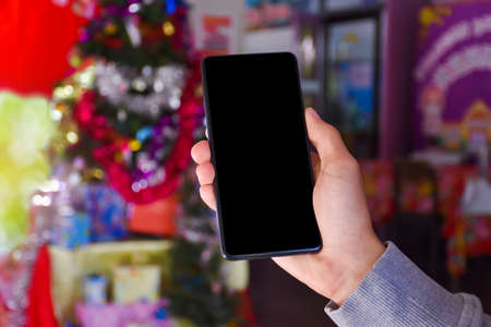 Blank touch screen smartphone holding in hand, Mock up, copyspace, template and technology concept.
