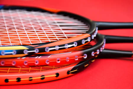 Badminton rackets on red floor in indoor badminton court, copy space, soft and selective focus.の写真素材