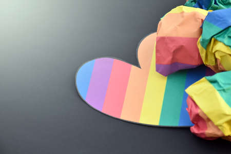 Rainbow colored paper cut out in the shape of a heart, concept for lgbtq+ community celebration in pride month and special lgbtq+ occasion around the world.の写真素材