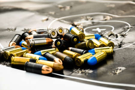 Pile of bullets or ammunitions on black man-target shooting, soft and selective focus on bullets.の写真素材
