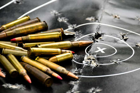 Pile of bullets or ammunitions on black man-target shooting, soft and selective focus on bullets.の写真素材