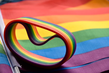 Rainbow wristbands, symbol of lgbtq+, on rainbow flags, concept for lgbtq+ symbol wearing to attend the celebration events of lgbtq+ community around the world, soft and selective focus.の写真素材