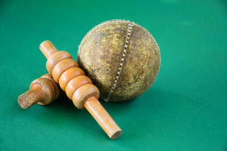 Cricket sport training equipments; leather balls and wickets on green floor, soft and selective...