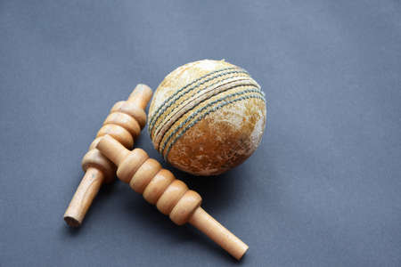Cricket sport training equipments; leather balls and wickets on dark floor, soft and selective focus. Cricket sports lovers around the world concept.の写真素材
