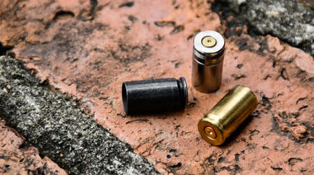 9mm pistol bullet shells on brick floor, soft and selective focus, concept for searching a key piece of evidence in a murder case at the scene.の写真素材