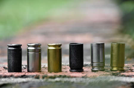 9mm pistol bullet shells on brick floor, soft and selective focus, concept for searching a key piece of evidence in a murder case at the scene.の写真素材
