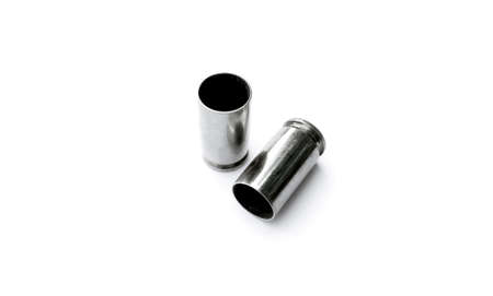 Isolated 9mm pistol bullet shells on white background.
