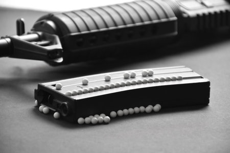 White plastic bullet balls of airsoft gun or bb gun on dark floor, soft and selective focus on white pellets.の写真素材