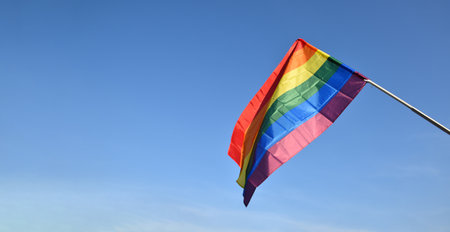 'HAPPY PRiDE MONTH 2023' on bluesky and rainbow flags background, concept for lgbtq+ celebrations in pride month, june, 2023.の写真素材